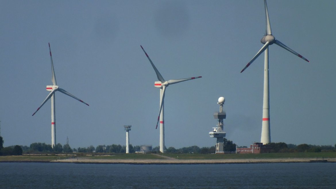 Wind turbines and a weather radar tower.