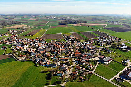 Aerial view of a village with many solar roofs.