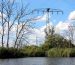 Electricity pylons close to a lake