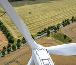 view from above of a windturbine in agrarian landscape 